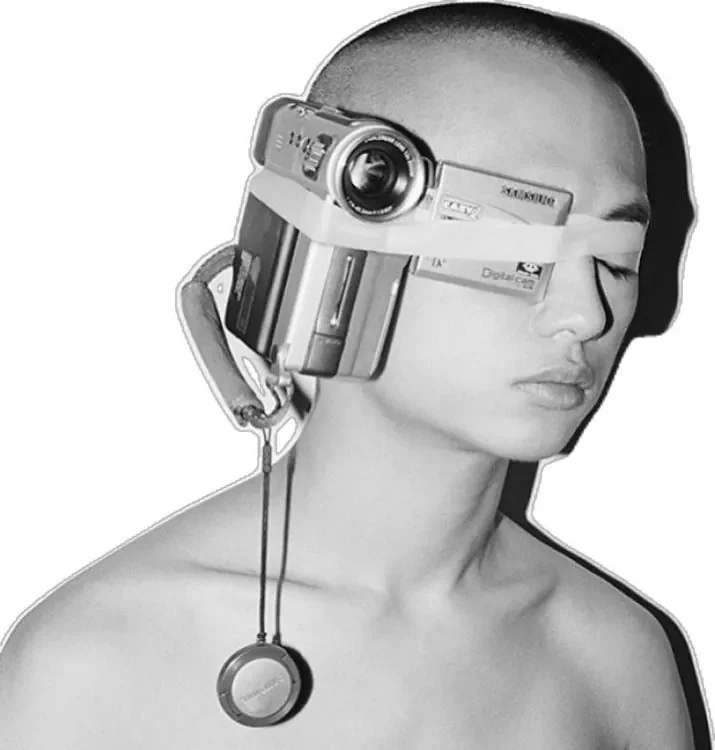 Portrait wearing a compact camera as a headpiece